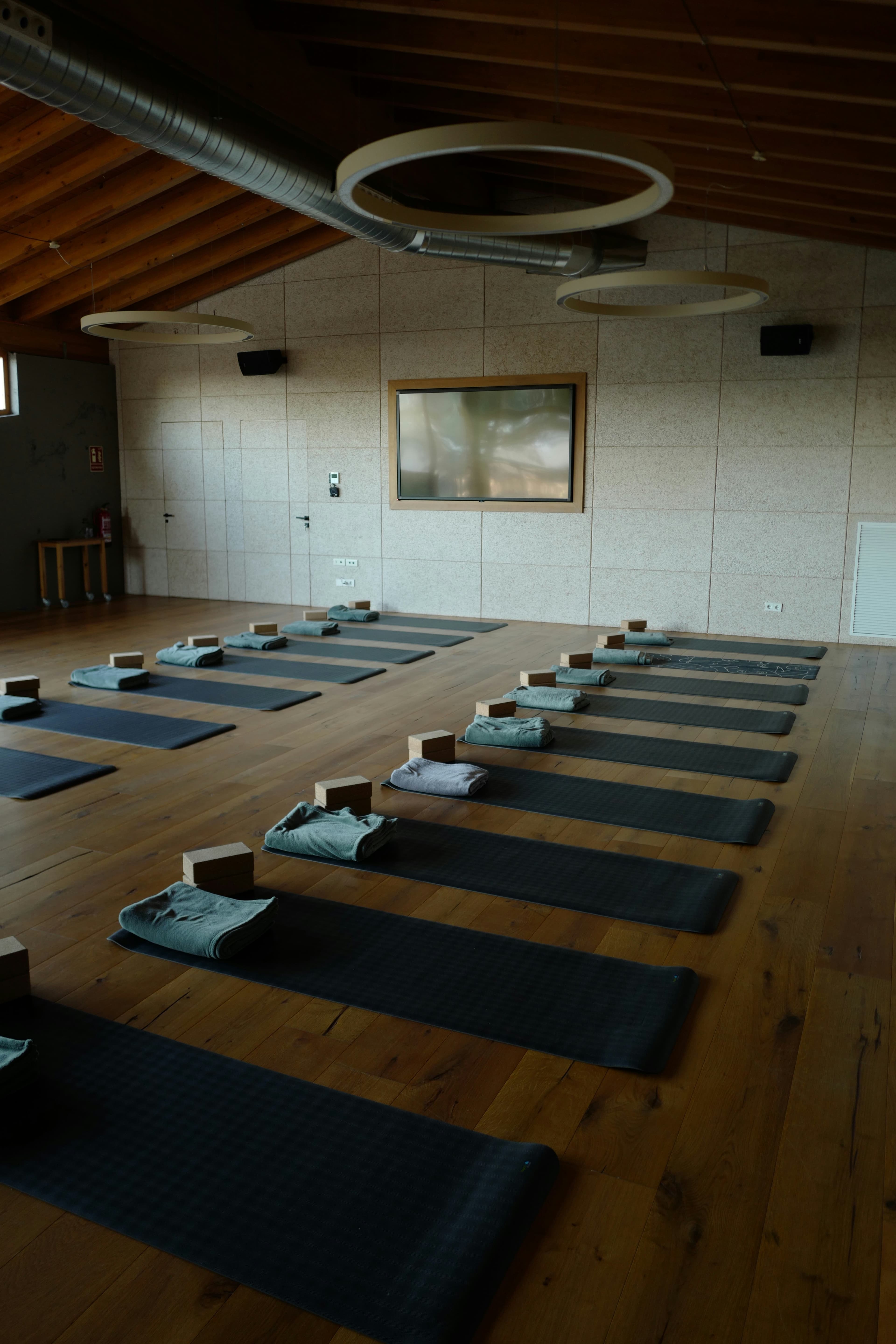Yoga studio with mats, blocks, and towels arranged for a class